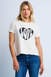 Woman wearing a white t-shirt with a black heart and 'LOVE' design, standing against a plain background.
